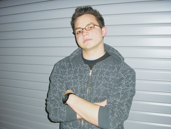 Student musician posing in front of wall