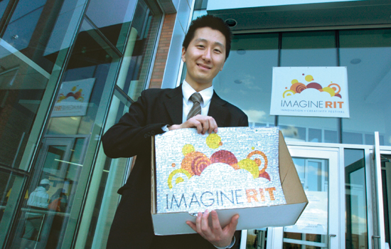 Student holding "Imagine RIT" signs