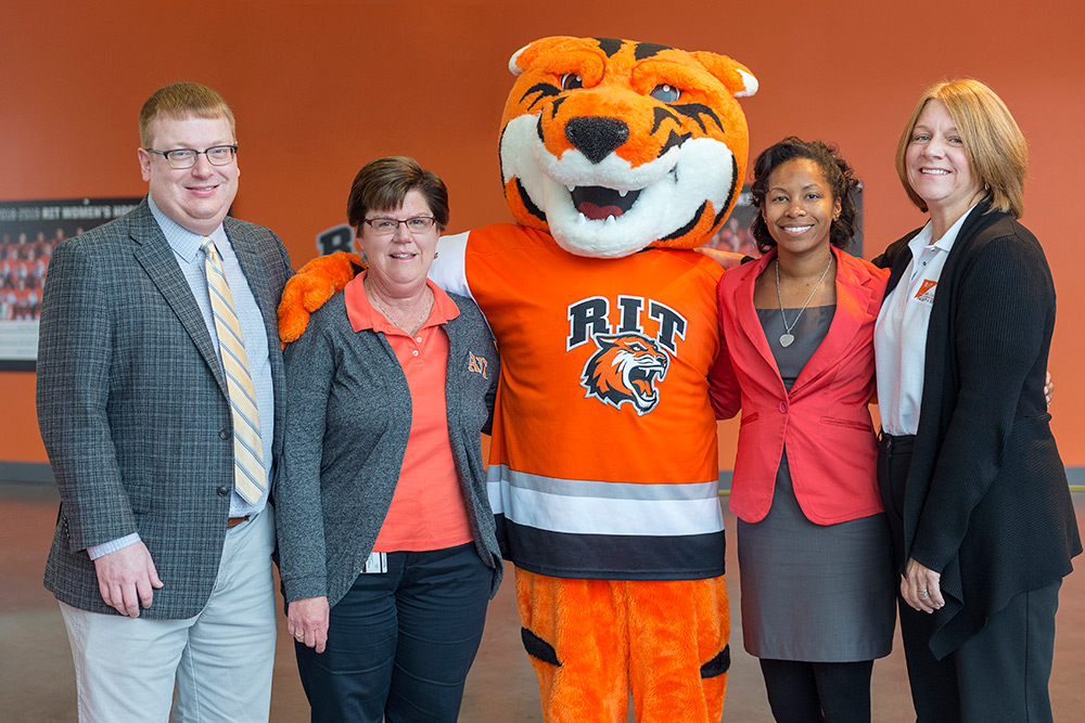 The winners of the Golden Brick Award pose for a photo with RITchie the Tiger, RIT's mascot.