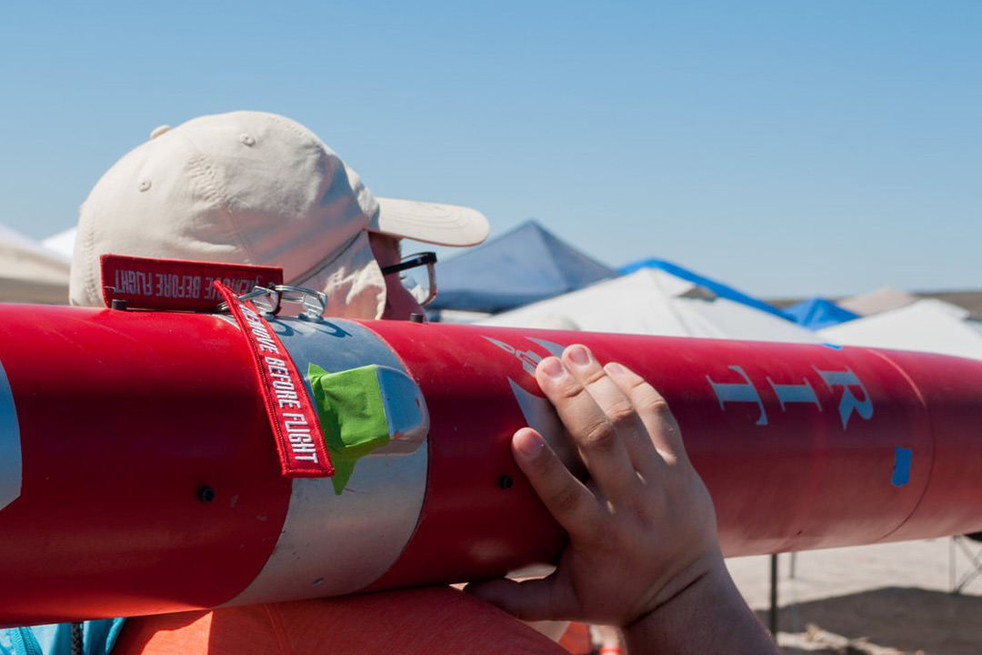 Man holds rocket on shoulder.