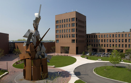Sculpture in front of brick buildings