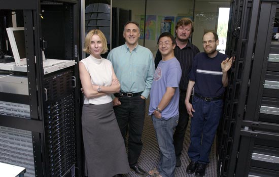 Professors standing near computer servers