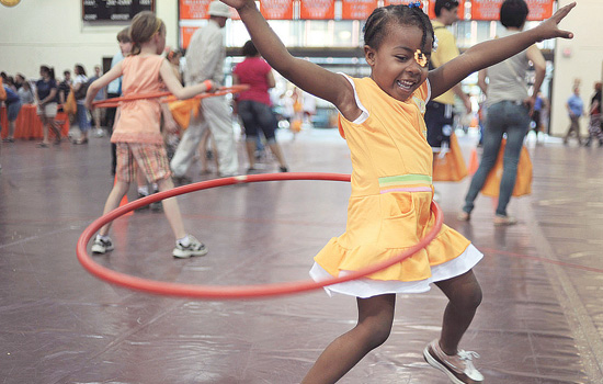young girl hula hooping.