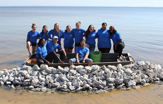 group of people in and around a small boat.