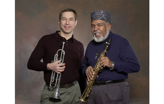 Two musicians posing for camera