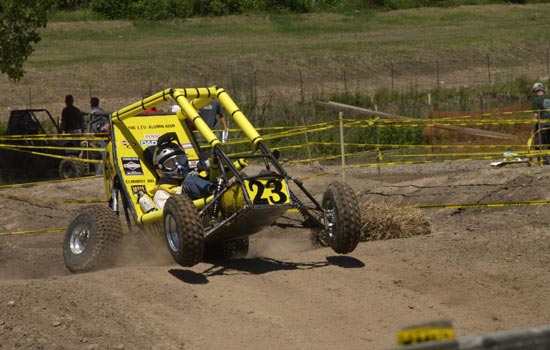 Off road vehicle driving along dirt course