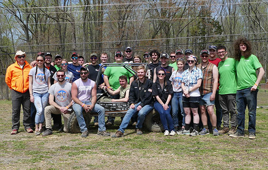 RIT's Baja race team poses for a photo with car.