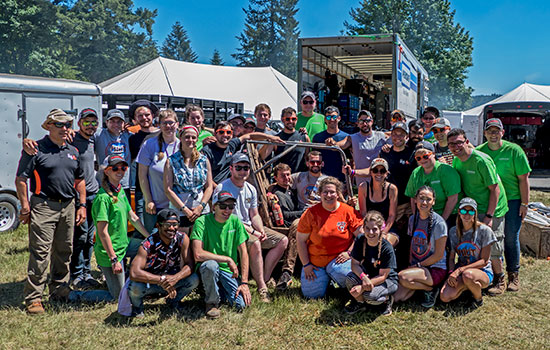 RIT's Baja Racing team pose for a photo with their car.