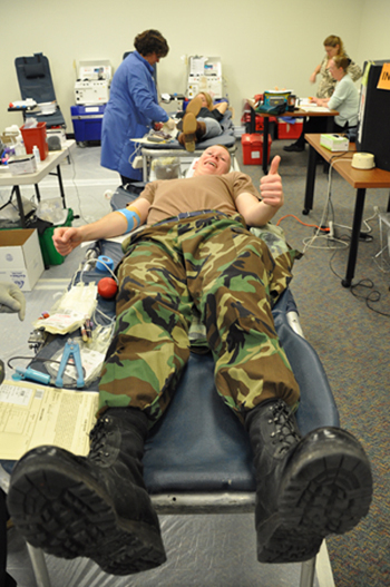 Person giving blood at blood drive