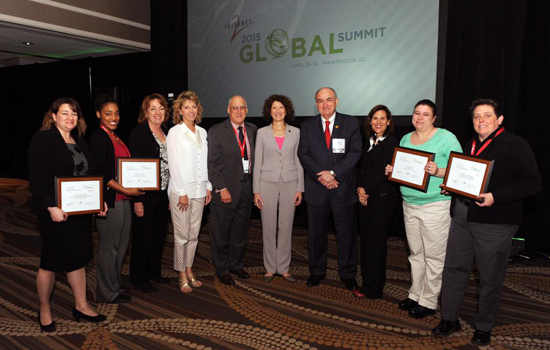 People posing with awards at event