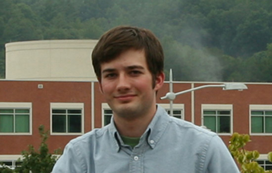 Student posing in front of building