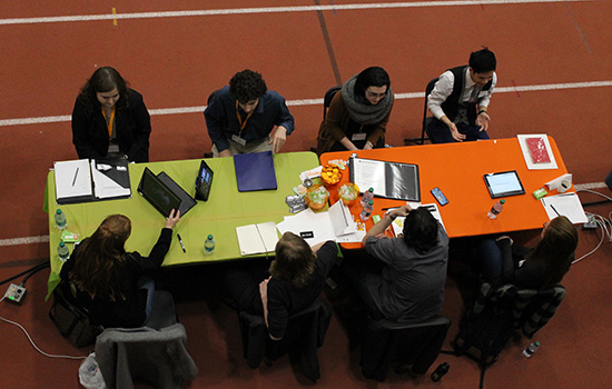 People studying at tables in gym