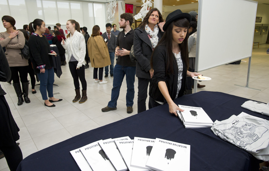 person picking up a magazine from a table at a reception.