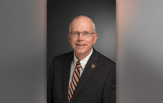 Headshot of President Munson in a suit.