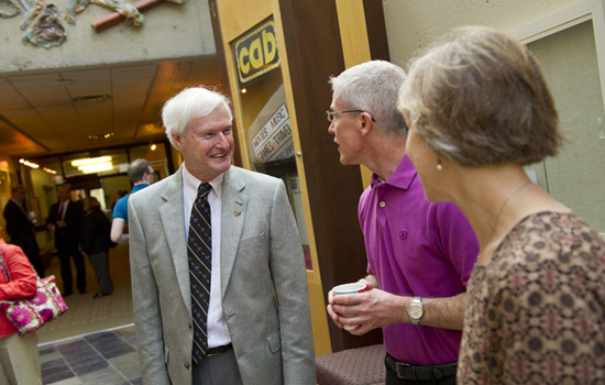 RIT President talking with people in hallway