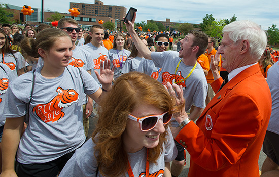 People gathered on pathway meeting RIT President