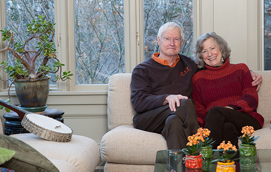RIT President Bill Destler posing on couch with his wife