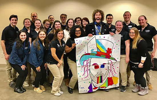 Members of the College Activities Board pose for a photo with T.J. Miller.