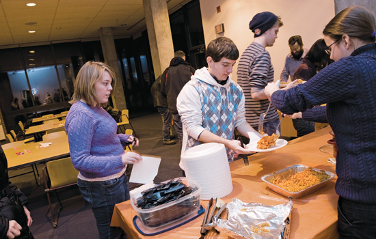 People getting food at table