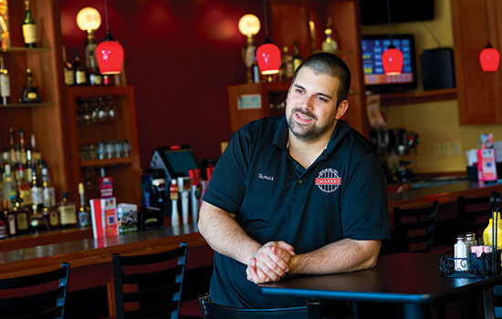 Person posing behind counter