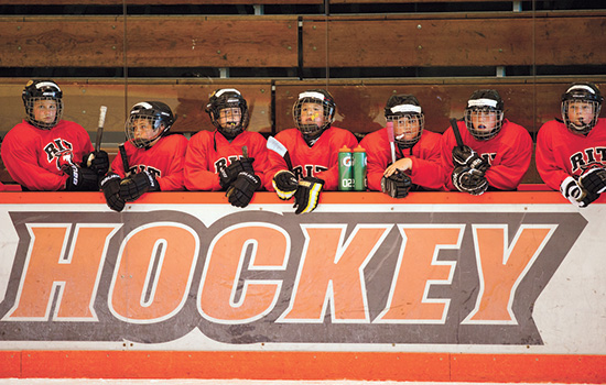 Kids posing in hockey gear