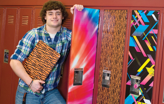 Person posing next to decorative lockers