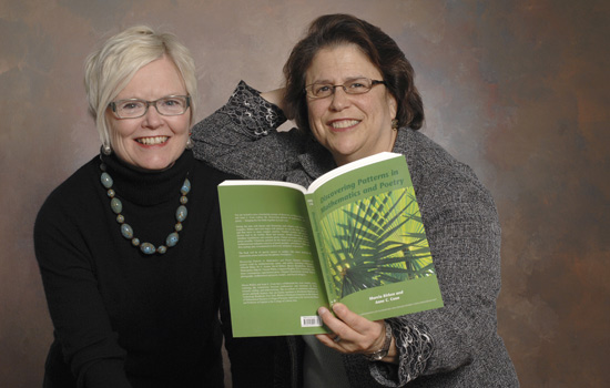 Two Professors holding a book