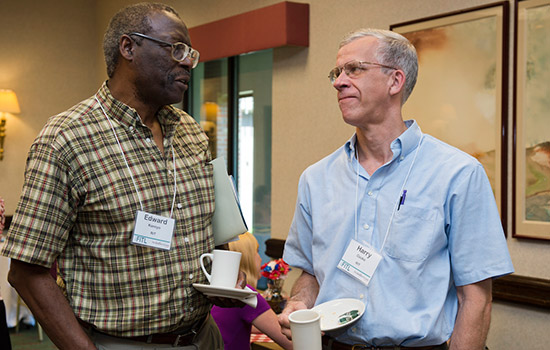 Two people talking at event.