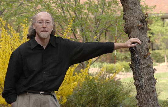 RIT Professor posing near a tree