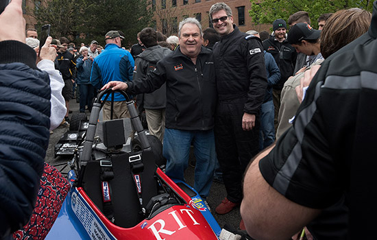 People posing with RIT Formula car