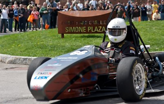 Person driving formula car on track