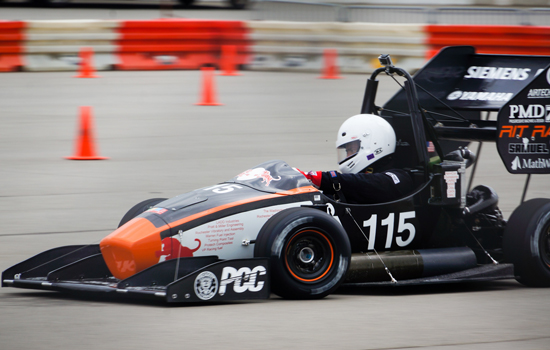 Person driving formula car on track