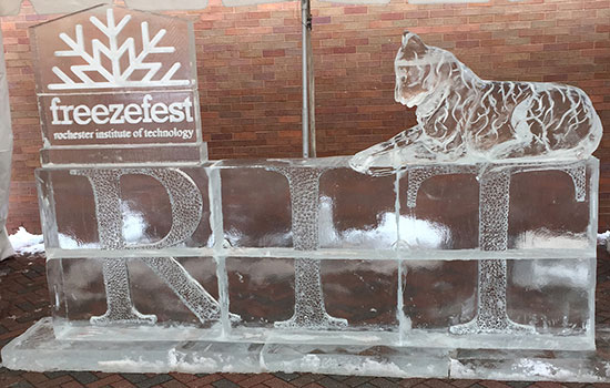Ice carving display saying RIT with a tiger on top.