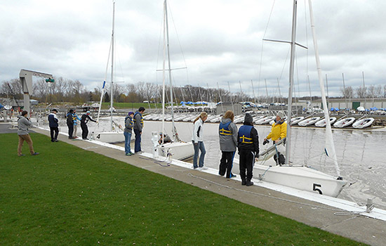 People rigging sailboats