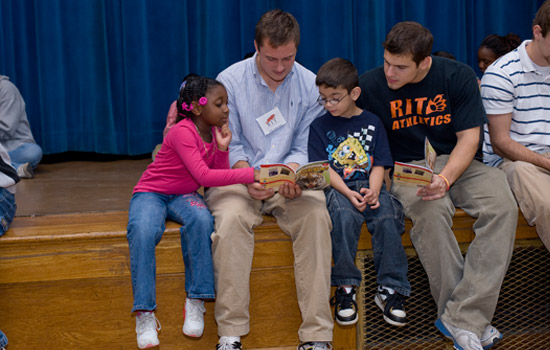 Student reading books to kids