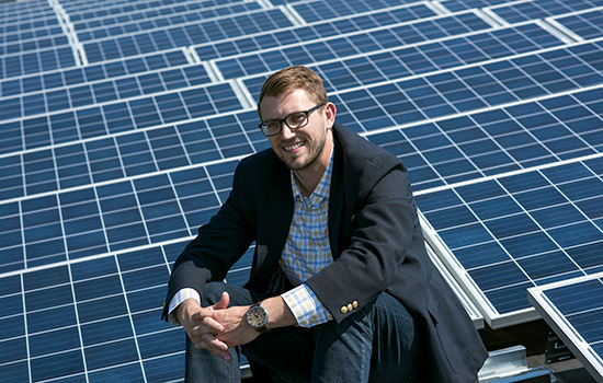 Mike Waller pictured in front of solar array.