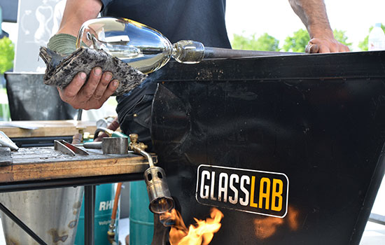 Someone cleaning glass while working in glass lab.