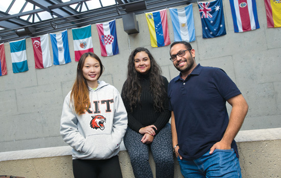 People posing in front of flags 