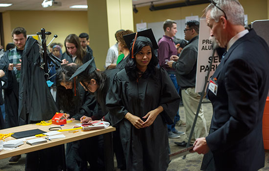 Students dressed in graduation gowns.