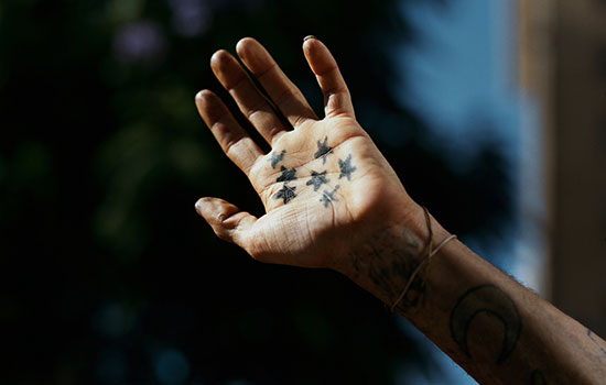 Stars drawn on the palm of a hand.