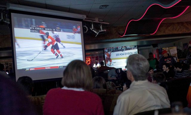 People gathered watching hockey 