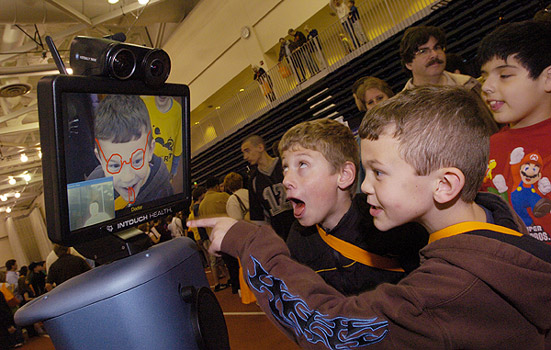 People looking at interactive screen at event