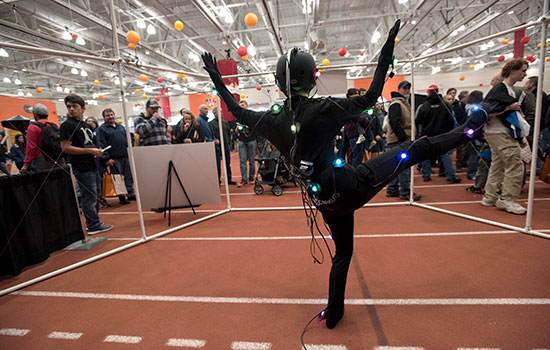 Person in black wearing colored orbs at imagine rit.