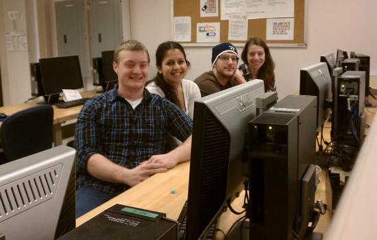 People posing in computer lab