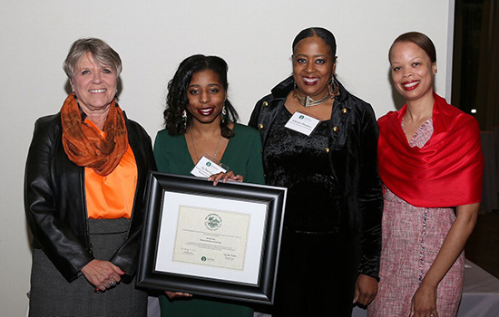 Deborah Stendardi, Ja'Nai Gray, Ashante Hendrix, and Sharitta Gross-Smith pose for a photo, Ja'Nai holding up an award certificate.