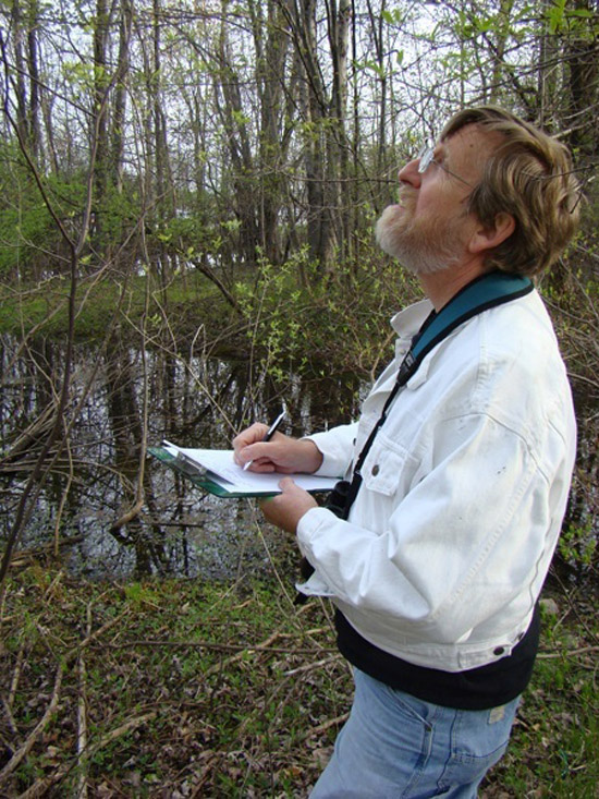 Professor with clipboard observing nature