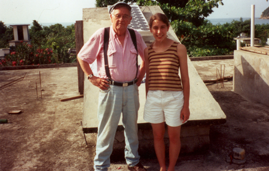 Two people posing for camera on top of building