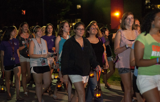 People walking down pathway at night