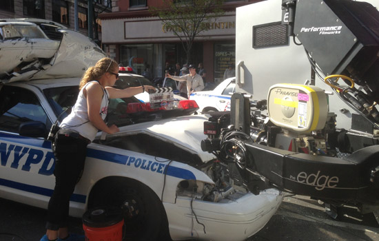 Person working on police car in front of camera