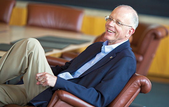 Professor posing for camera in chair